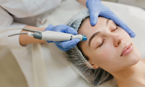Closeup portrait of beautiful woman during cosmetology therapy in beauty salon. Professional dermatology procedures, lifting, rejuvenation, modern devices, healthcare
